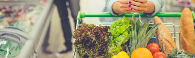 Grocery aisle with bright end-cap deals and eye-level products, highlighting common supermarket tactics like ‘2-for’ offers and strategic placement.