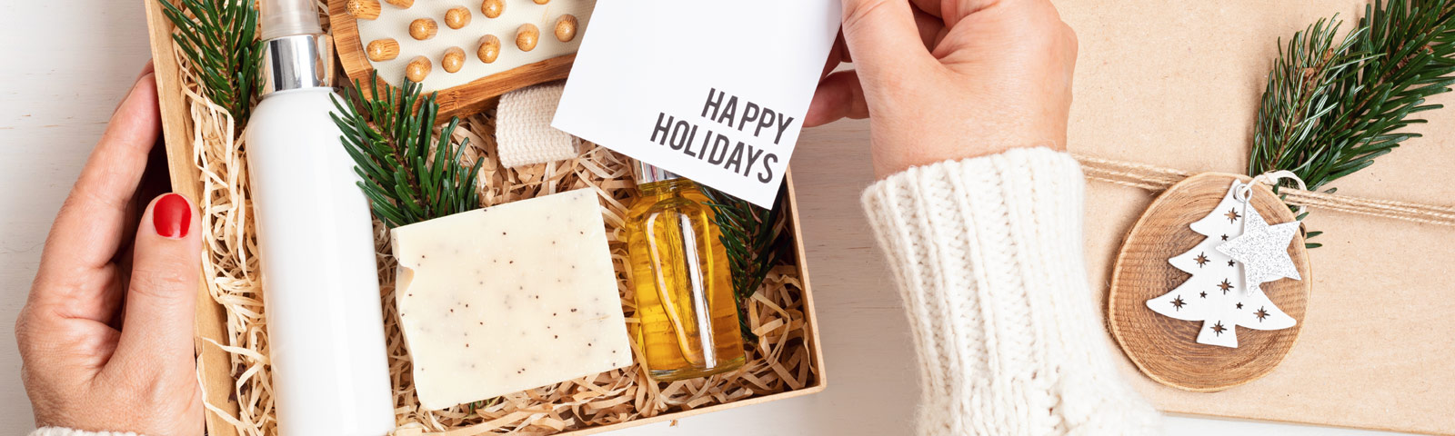 A festive gift setup featuring a yoga mat, healthy cookbook, smoothie maker, and herbal teas wrapped in holiday paper—representing wellness-inspired Christmas gifts.